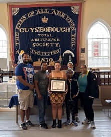 Group photo of Taya with award.